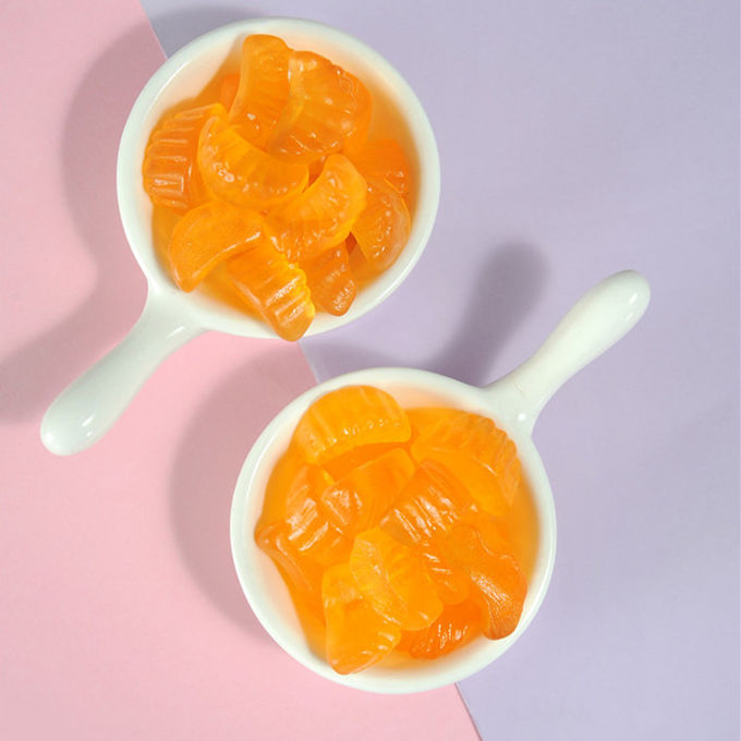 オレンジ味は粘着性のビタミンのフルーツによって形づけられるハラールの完全菜食主義者の粘着性の菓子をからかいます